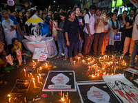 Citizens light candles in solidarity with the victim doctor who was raped and murdered at RG Kar Medical College and Hospital, during a prot...