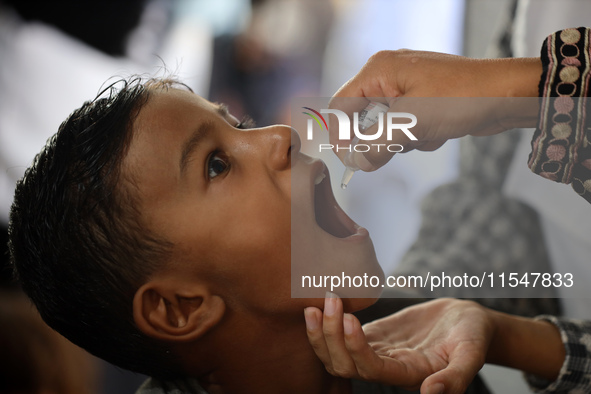 A Palestinian child receives a polio vaccination in the UK-MED field hospital in Khan Younis in the southern Gaza Strip, on September 5, 202...