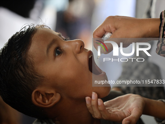 A Palestinian child receives a polio vaccination in the UK-MED field hospital in Khan Younis in the southern Gaza Strip, on September 5, 202...