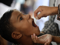 A Palestinian child receives a polio vaccination in the UK-MED field hospital in Khan Younis in the southern Gaza Strip, on September 5, 202...