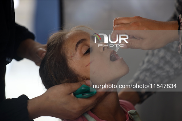 A Palestinian child receives a polio vaccination in the UK-MED field hospital in Khan Younis in the southern Gaza Strip, on September 5, 202...