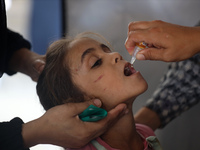 A Palestinian child receives a polio vaccination in the UK-MED field hospital in Khan Younis in the southern Gaza Strip, on September 5, 202...