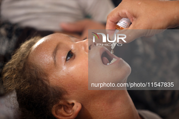 A Palestinian child receives a polio vaccination in the UK-MED field hospital in Khan Younis in the southern Gaza Strip, on September 5, 202...