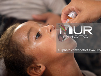 A Palestinian child receives a polio vaccination in the UK-MED field hospital in Khan Younis in the southern Gaza Strip, on September 5, 202...