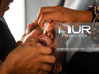 A Palestinian child receives a polio vaccination in the UK-MED field hospital in Khan Younis in the southern Gaza Strip, on September 5, 202...