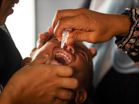 A Palestinian child receives a polio vaccination in the UK-MED field hospital in Khan Younis in the southern Gaza Strip, on September 5, 202...