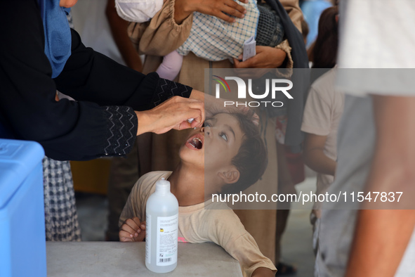 A Palestinian child receives a polio vaccination in the UK-MED field hospital in Khan Younis in the southern Gaza Strip, on September 5, 202...