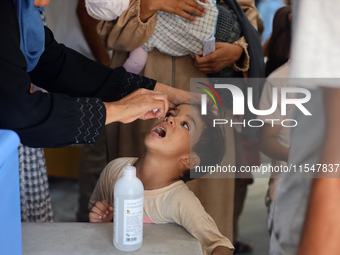 A Palestinian child receives a polio vaccination in the UK-MED field hospital in Khan Younis in the southern Gaza Strip, on September 5, 202...