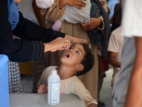 A Palestinian child receives a polio vaccination in the UK-MED field hospital in Khan Younis in the southern Gaza Strip, on September 5, 202...