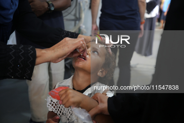 A Palestinian child receives a polio vaccination in the UK-MED field hospital in Khan Younis in the southern Gaza Strip, on September 5, 202...