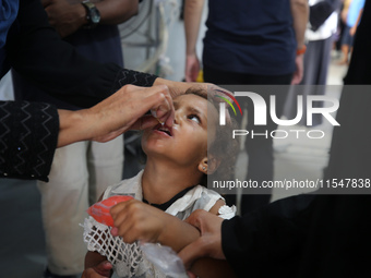 A Palestinian child receives a polio vaccination in the UK-MED field hospital in Khan Younis in the southern Gaza Strip, on September 5, 202...