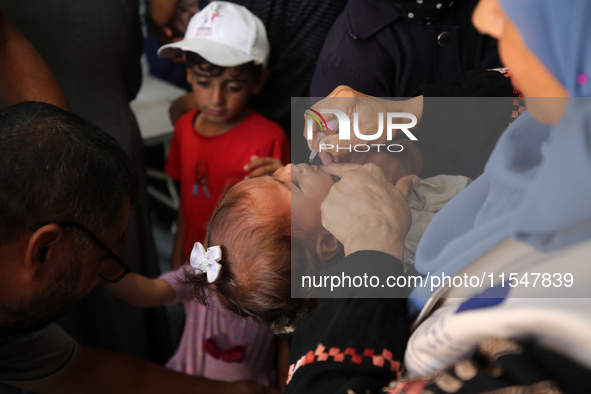 A Palestinian child receives a polio vaccination in the UK-MED field hospital in Khan Younis in the southern Gaza Strip, on September 5, 202...