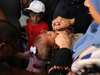 A Palestinian child receives a polio vaccination in the UK-MED field hospital in Khan Younis in the southern Gaza Strip, on September 5, 202...