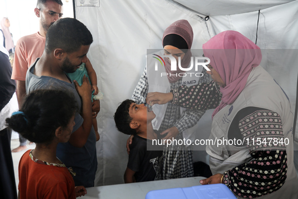 A Palestinian child receives a polio vaccination in the UK-MED field hospital in Khan Younis in the southern Gaza Strip, on September 5, 202...