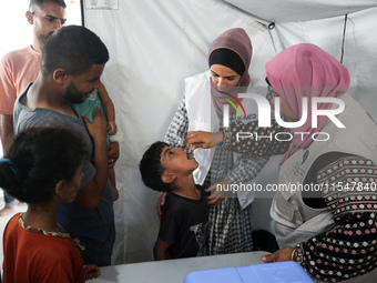 A Palestinian child receives a polio vaccination in the UK-MED field hospital in Khan Younis in the southern Gaza Strip, on September 5, 202...