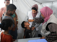 A Palestinian child receives a polio vaccination in the UK-MED field hospital in Khan Younis in the southern Gaza Strip, on September 5, 202...