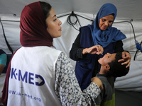 A Palestinian child receives a polio vaccination in the UK-MED field hospital in Khan Younis in the southern Gaza Strip, on September 5, 202...