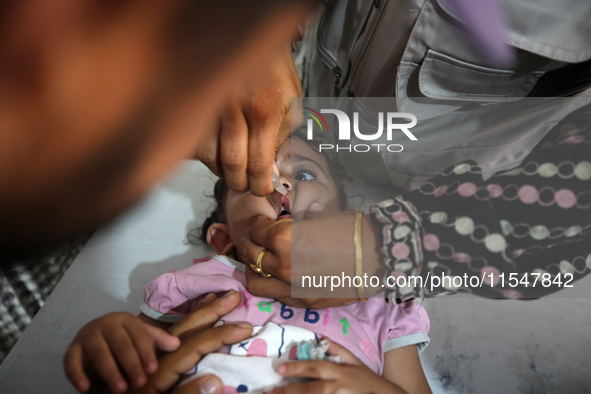 A Palestinian child receives a polio vaccination in the UK-MED field hospital in Khan Younis in the southern Gaza Strip, on September 5, 202...