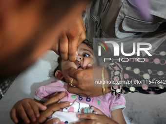 A Palestinian child receives a polio vaccination in the UK-MED field hospital in Khan Younis in the southern Gaza Strip, on September 5, 202...