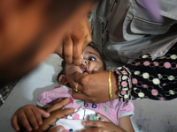 A Palestinian child receives a polio vaccination in the UK-MED field hospital in Khan Younis in the southern Gaza Strip, on September 5, 202...