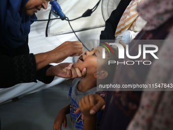 A Palestinian child receives a polio vaccination in the UK-MED field hospital in Khan Younis in the southern Gaza Strip, on September 5, 202...