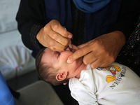 A Palestinian child receives a polio vaccination in the UK-MED field hospital in Khan Younis in the southern Gaza Strip, on September 5, 202...