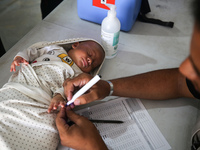 A Palestinian child receives a polio vaccination in the UK-MED field hospital in Khan Younis in the southern Gaza Strip, on September 5, 202...