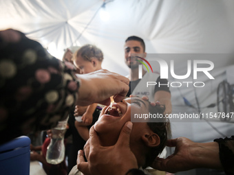 A Palestinian child receives a polio vaccination in the UK-MED field hospital in Khan Younis in the southern Gaza Strip, on September 5, 202...