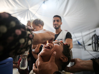 A Palestinian child receives a polio vaccination in the UK-MED field hospital in Khan Younis in the southern Gaza Strip, on September 5, 202...