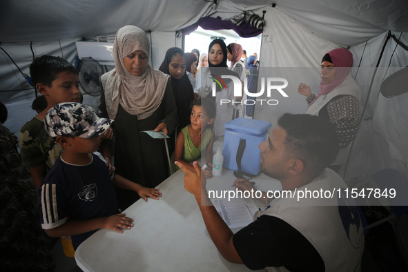 Palestinian children receive polio vaccinations at the UK-MED field hospital in Khan Younis in the southern Gaza Strip, on September 5, 2024...