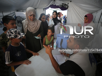 Palestinian children receive polio vaccinations at the UK-MED field hospital in Khan Younis in the southern Gaza Strip, on September 5, 2024...