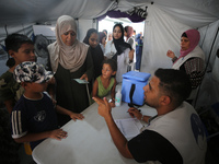 Palestinian children receive polio vaccinations at the UK-MED field hospital in Khan Younis in the southern Gaza Strip, on September 5, 2024...