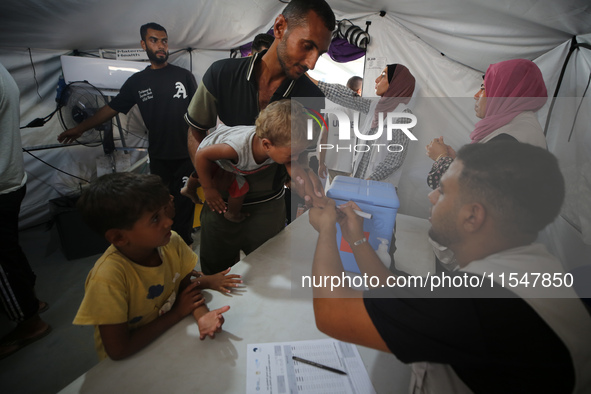 Palestinian children receive polio vaccinations at the UK-MED field hospital in Khan Younis in the southern Gaza Strip, on September 5, 2024...