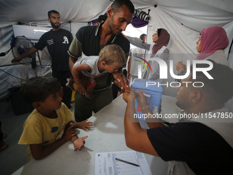 Palestinian children receive polio vaccinations at the UK-MED field hospital in Khan Younis in the southern Gaza Strip, on September 5, 2024...