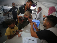 Palestinian children receive polio vaccinations at the UK-MED field hospital in Khan Younis in the southern Gaza Strip, on September 5, 2024...