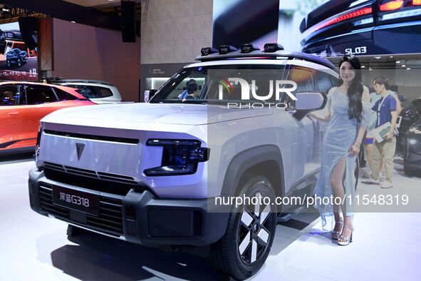 A model displays a new car at the 23rd Autumn International Auto Show in Qingdao, China, on September 5, 2024. 