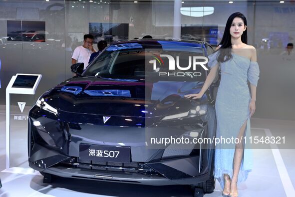 A model displays a new car at the 23rd Autumn International Auto Show in Qingdao, China, on September 5, 2024. 