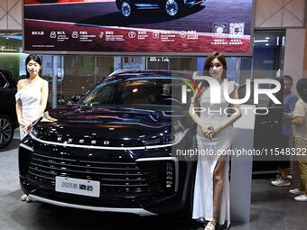 A model displays a new car at the 23rd Autumn International Auto Show in Qingdao, China, on September 5, 2024. (