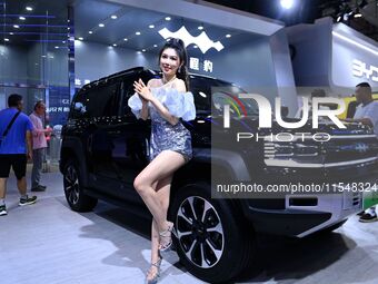 A model displays a new car at the 23rd Autumn International Auto Show in Qingdao, China, on September 5, 2024. (