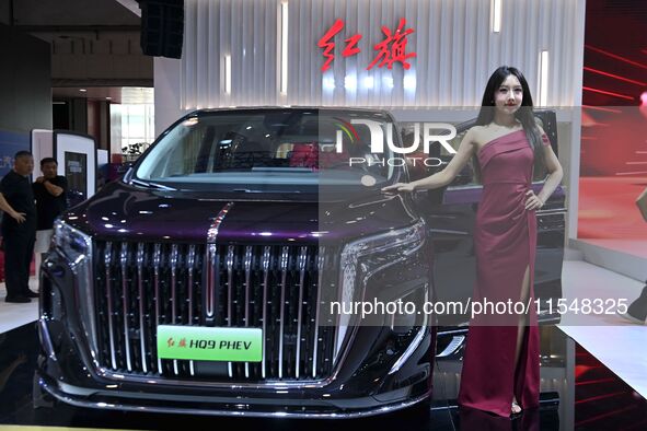 A model displays a new car at the 23rd Autumn International Auto Show in Qingdao, China, on September 5, 2024. 