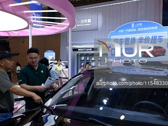 Promotional information about replacement vehicles is seen at the 23rd Autumn International Auto Show 2024 in Qingdao, China, on September 5...