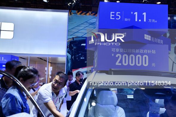 Promotional information about replacement vehicles is seen at the 23rd Autumn International Auto Show 2024 in Qingdao, China, on September 5...