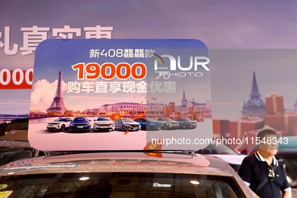 Promotional information about replacement vehicles is seen at the 23rd Autumn International Auto Show 2024 in Qingdao, China, on September 5...