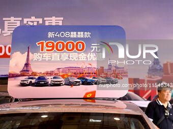 Promotional information about replacement vehicles is seen at the 23rd Autumn International Auto Show 2024 in Qingdao, China, on September 5...