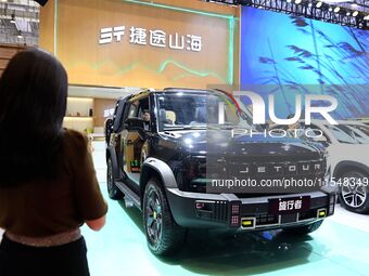 People look at various vehicles at the 23rd Autumn International Auto Show in Qingdao, China, on September 5, 2024. (