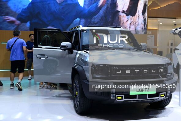 People look at various vehicles at the 23rd Autumn International Auto Show in Qingdao, China, on September 5, 2024. 