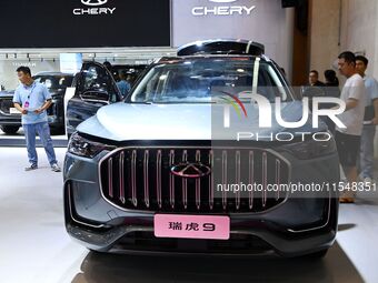 People look at various vehicles at the 23rd Autumn International Auto Show in Qingdao, China, on September 5, 2024. (