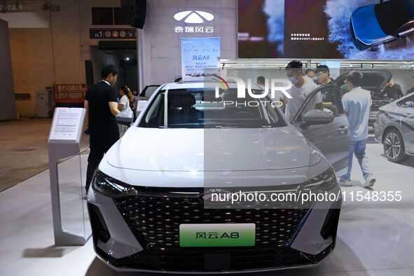 People look at various vehicles at the 23rd Autumn International Auto Show in Qingdao, China, on September 5, 2024. 