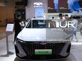 People look at various vehicles at the 23rd Autumn International Auto Show in Qingdao, China, on September 5, 2024. (