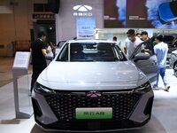 People look at various vehicles at the 23rd Autumn International Auto Show in Qingdao, China, on September 5, 2024. (